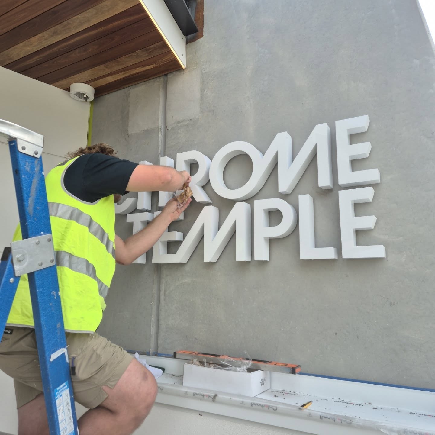 Chrome temple sign installation